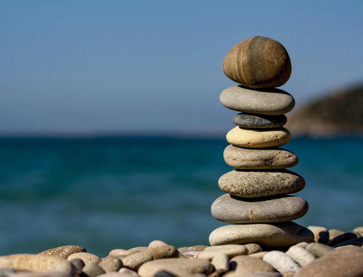Photo by ABHIJEET SINGH close up of a rock cairn